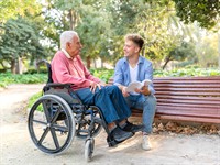 shutterstock_2706754815_young man with senior in wheelchair_jauns vīrietis ar pensionāru ratiņkrēslā.jpg