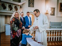 shulers Shutterstock_boy is receiving a baptism blessing from a priest_priesteris krista bērnu baznīcā.jpg