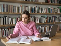 shutterstock_2608441639_studying in library_studē bibliotēkā.jpg