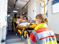 shutterstock_1827740816_paramedics puting man in car_mediķi ceļ cietušo mašīnā.jpg