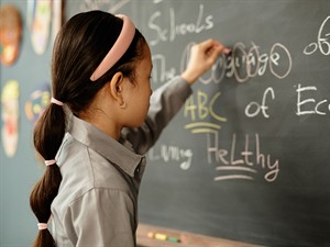 shutterstock_2518762091_girl writing on blackboard during lesson_meitene raksta uz tāfeles stundas laikā.jpg