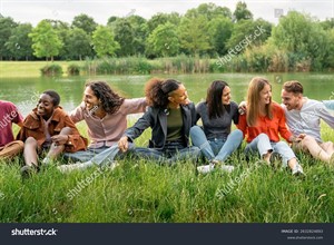 stock-photo-multicultural-group-of-young-students-sitting-on-the-grass-building-unity-and-sharing-an-authentic-2632824893.jpg