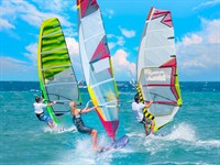 Shutterstock_1706977591_Windsurfer Surfing_Vindsērfotājs sērfo.jpg