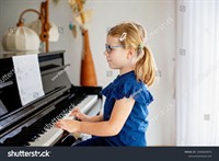 stock-photo-beautiful-little-preschool-girl-playing-piano-at-music-school-cute-child-having-fun-with-learning-2340020675.jpg