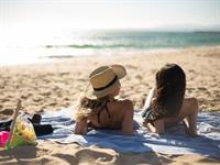 Shutterstock_2054981519_sunbathing on beach_sauļojas pludmalē.jpg