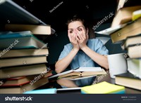 stock-photo-the-student-girl-wearily-looks-through-her-fingers-at-the-mountain-of-books-and-notebooks-on-her-1716589597.jpg