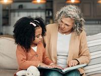 Shutterstock_2276429541_grandma reading for kid_vecmamma lasa bērnam.jpg